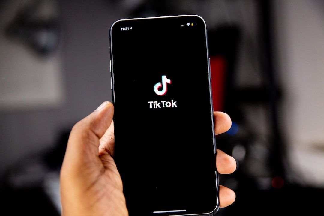 Hand holding phone with TikTok app, highlighting short form video content for marketing