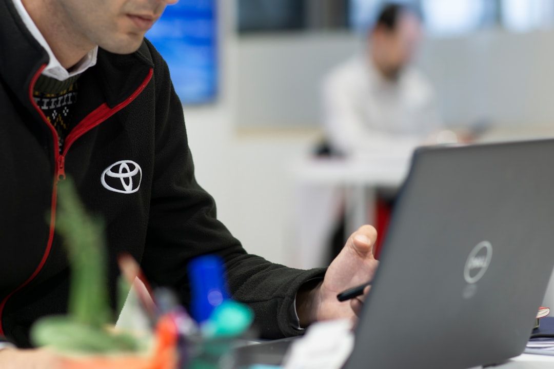 Man working on a  laptop, actively searching for an automotive keywords list.