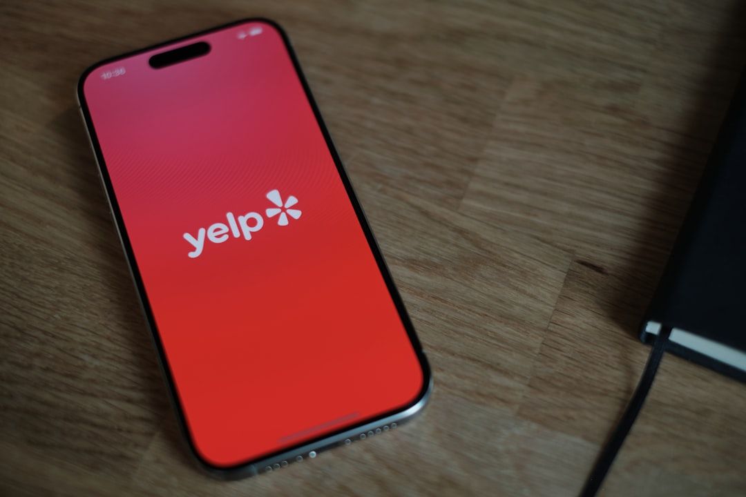 Yelp SEO app interface displayed on a smartphone placed on a wooden surface