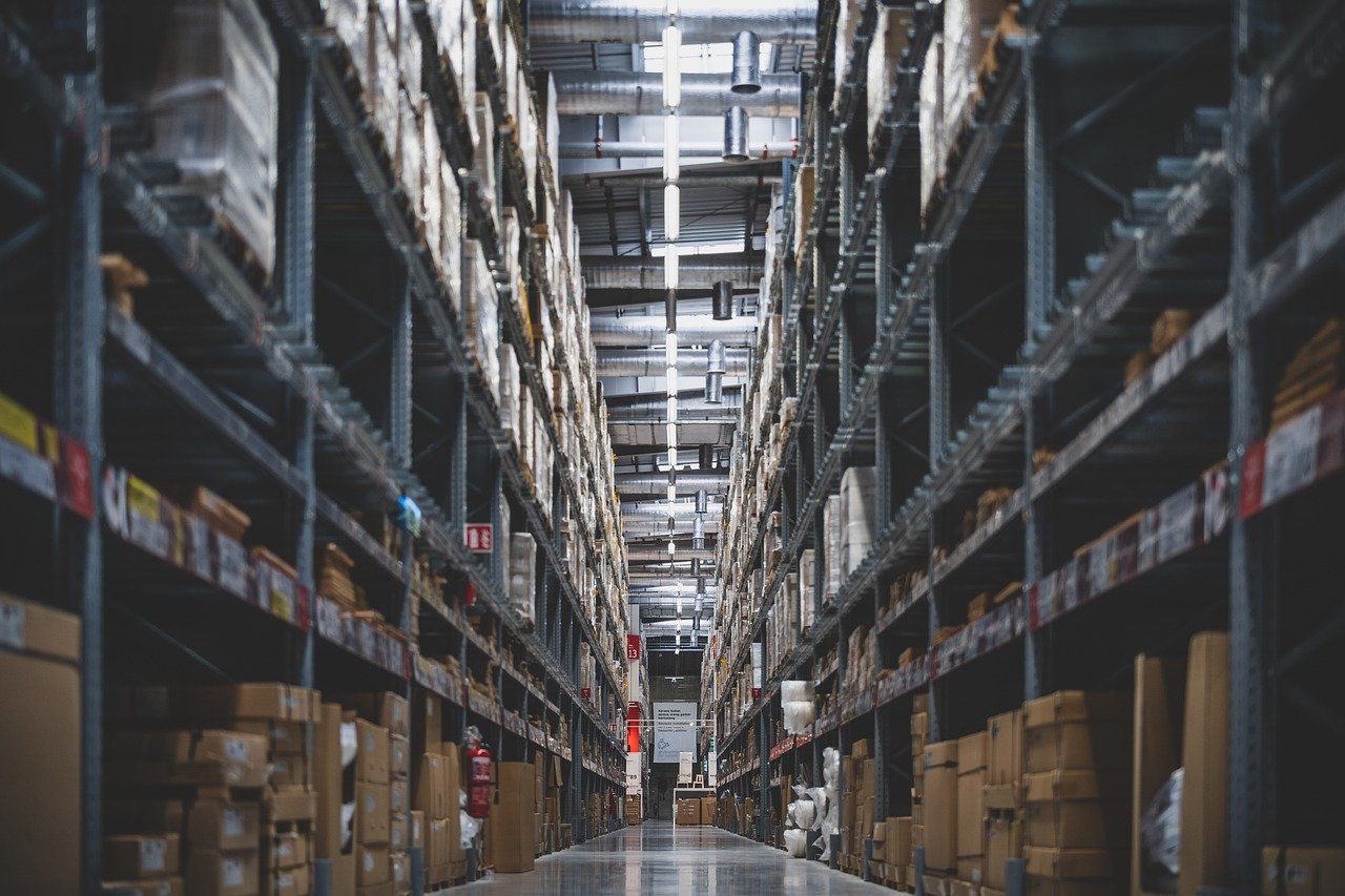 Warehouse aisle with stacked shelves, representing inventory focus in auto parts SEO
