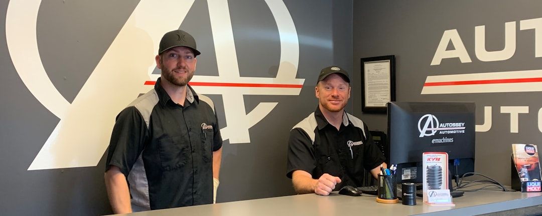 Auto shop staff at front desk, representing automotive customer retention and service experience
