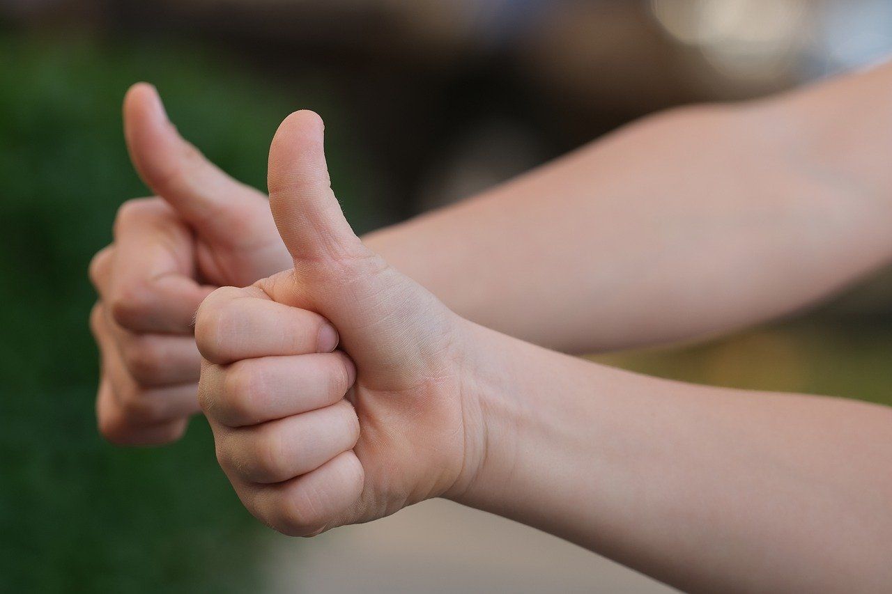 Customer testimonials with thumbs up for positive reviews