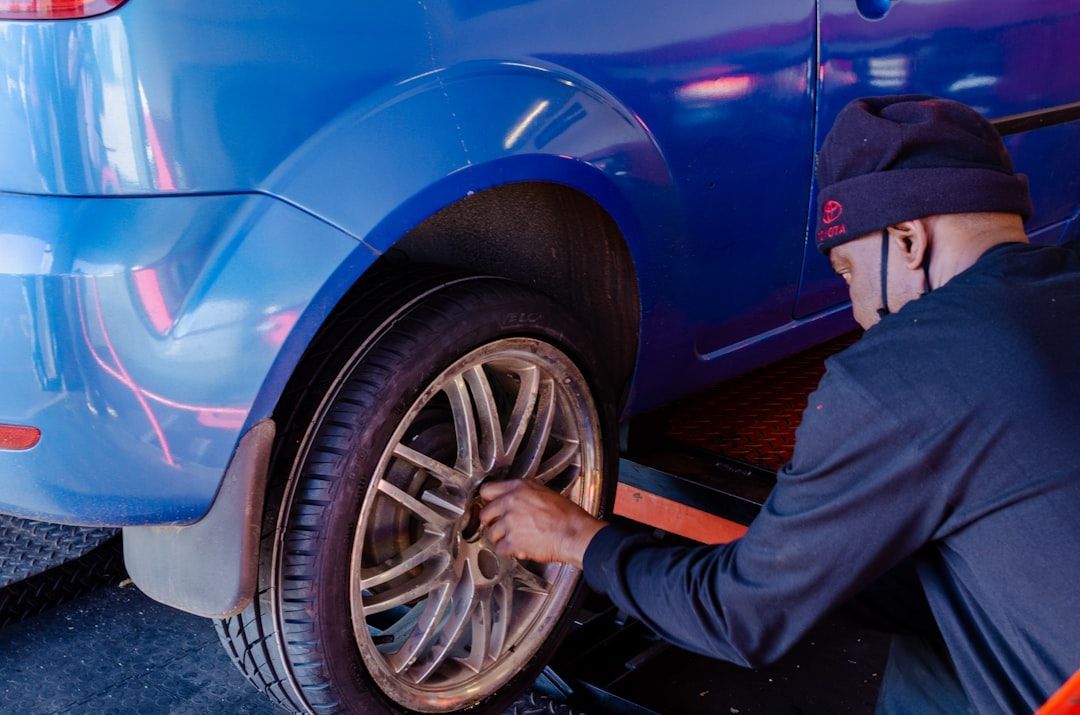 SEO for tire shop marketing with a mechanic servicing a vehicle tire in an auto garage