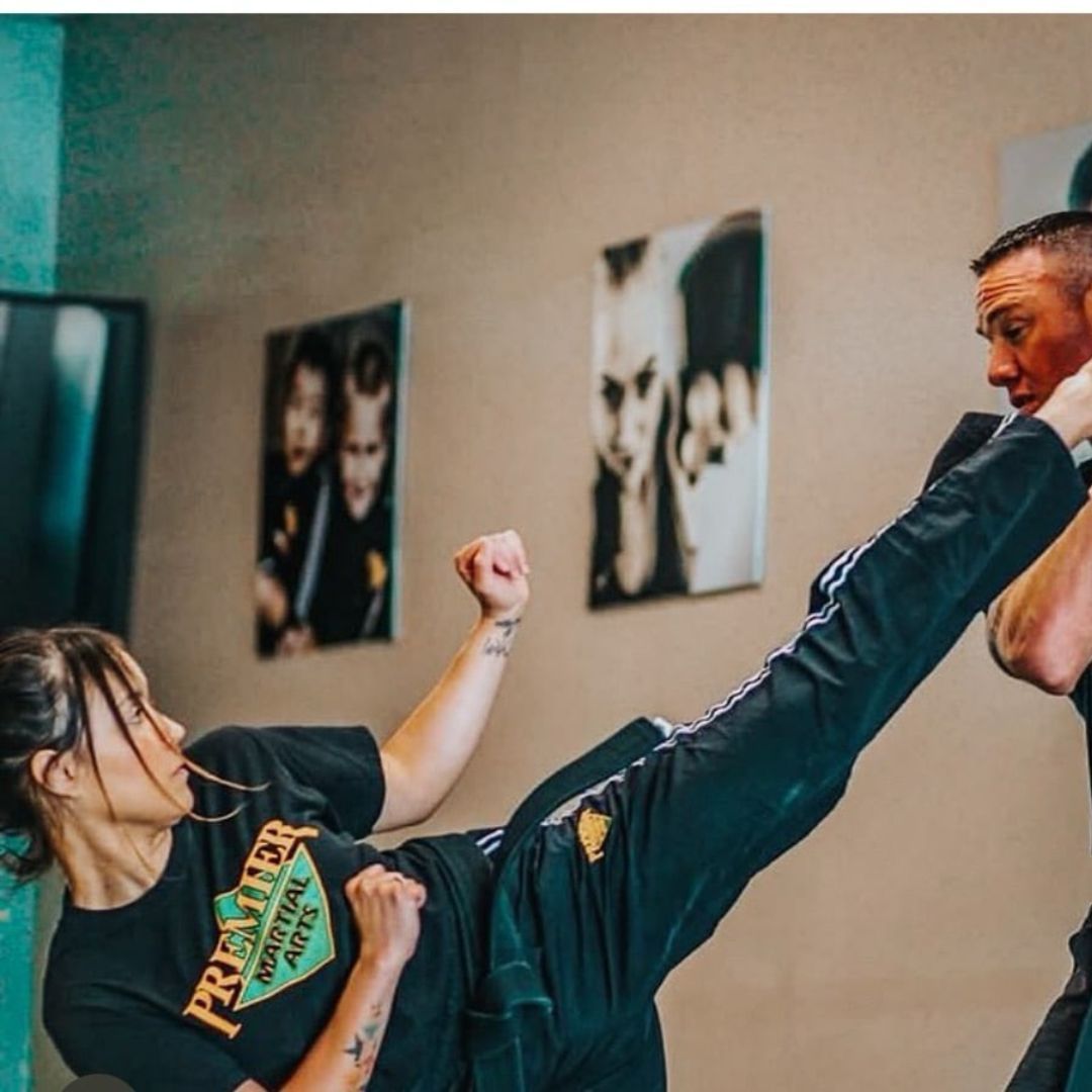 Two young men are practicing karate on a mat