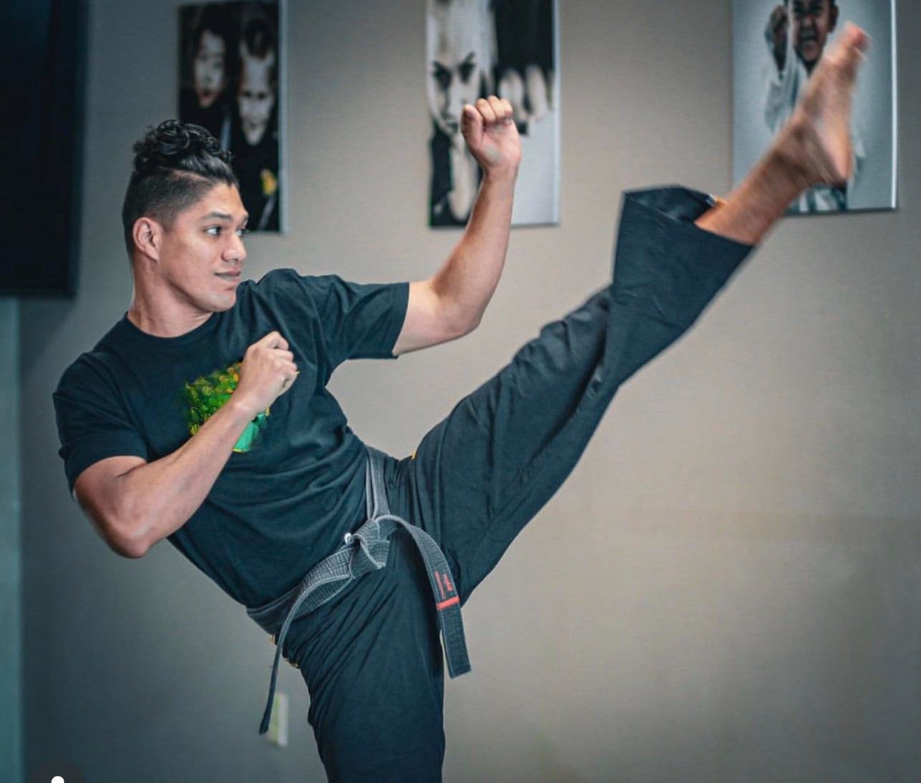 A group of men are practicing karate in a gym.