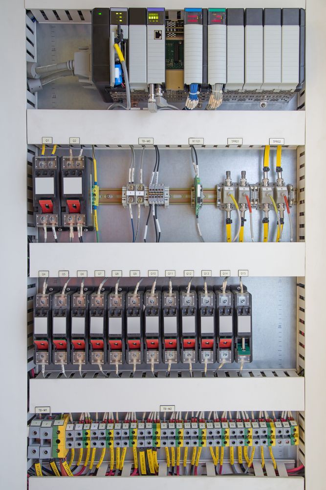 A Close Up of a Electrical Panel with Black Electric Boxes— Switchboard & Power Controls Pty Ltd in Alice Springs, NT