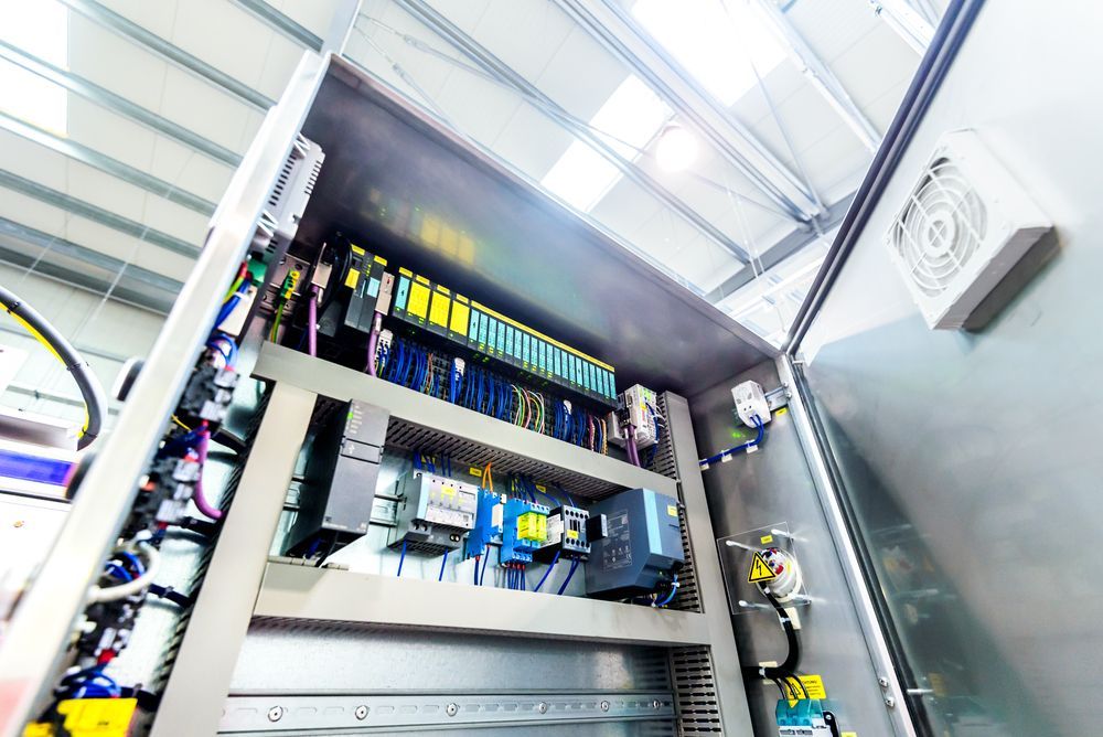 A Close Up of an Electrical Box With a Fan on the Wall — Switchboard & Power Controls Pty Ltd in Alice Springs, NT