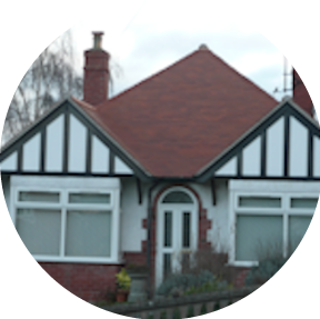 A house with a red roof and white trim