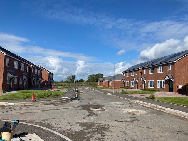 A row of houses on a sunny day with a blue sky