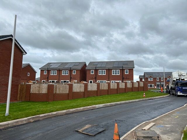A new row of houses, built in a residential area.