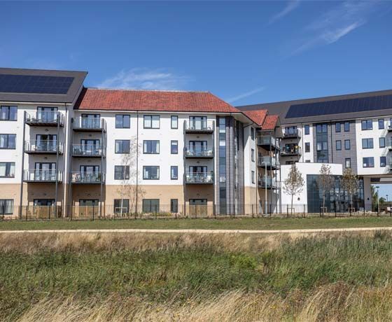 A large apartment building with solar panels on the roof