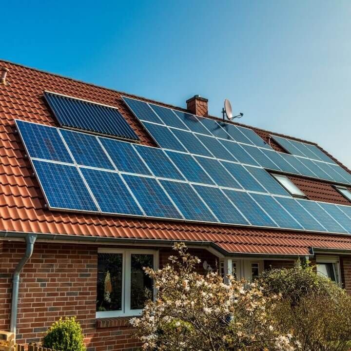 A brick house with solar panels on the roof
