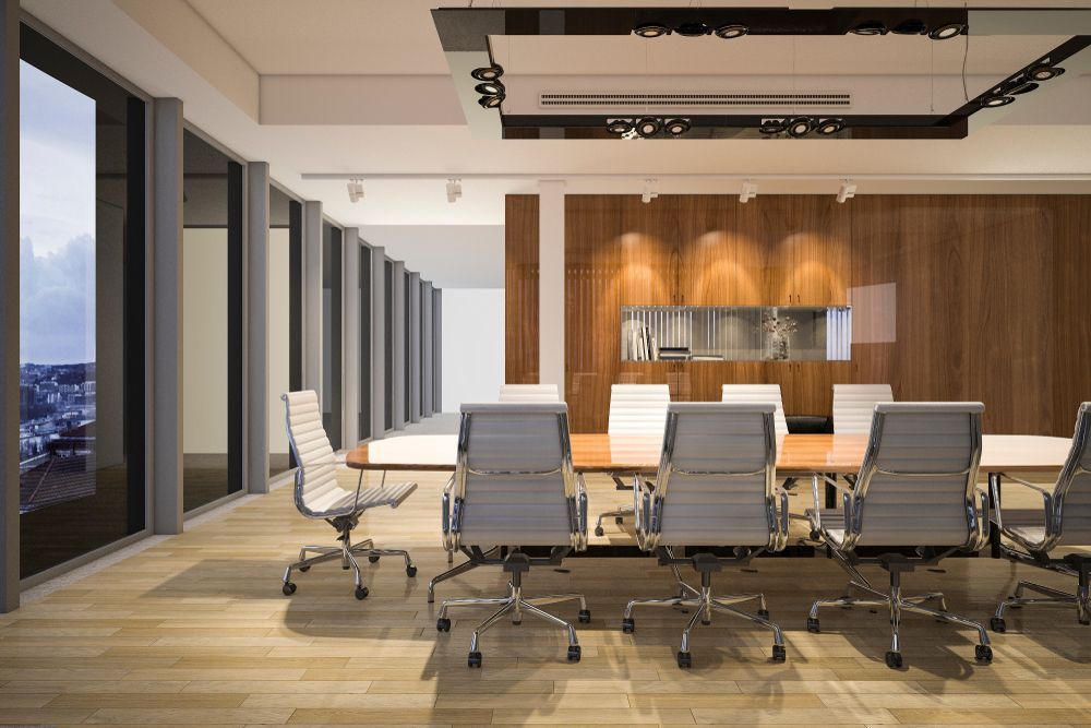 Modern Office Boardroom With Large Windows, Wooden Paneling, Long Table, And Rolling Chairs — Rocky Commercial Cleaners In Berserker, QLD