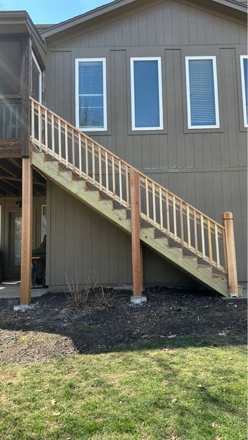 The back of a house with a deck and stairs