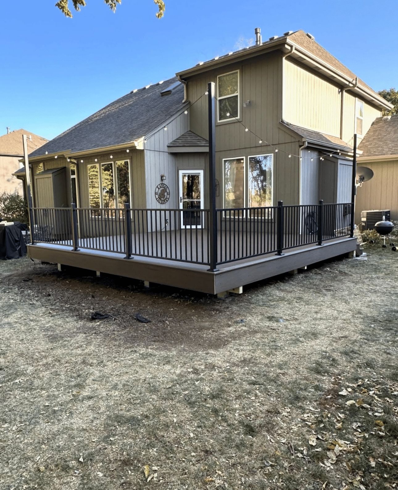 A house with a large deck in front of it.