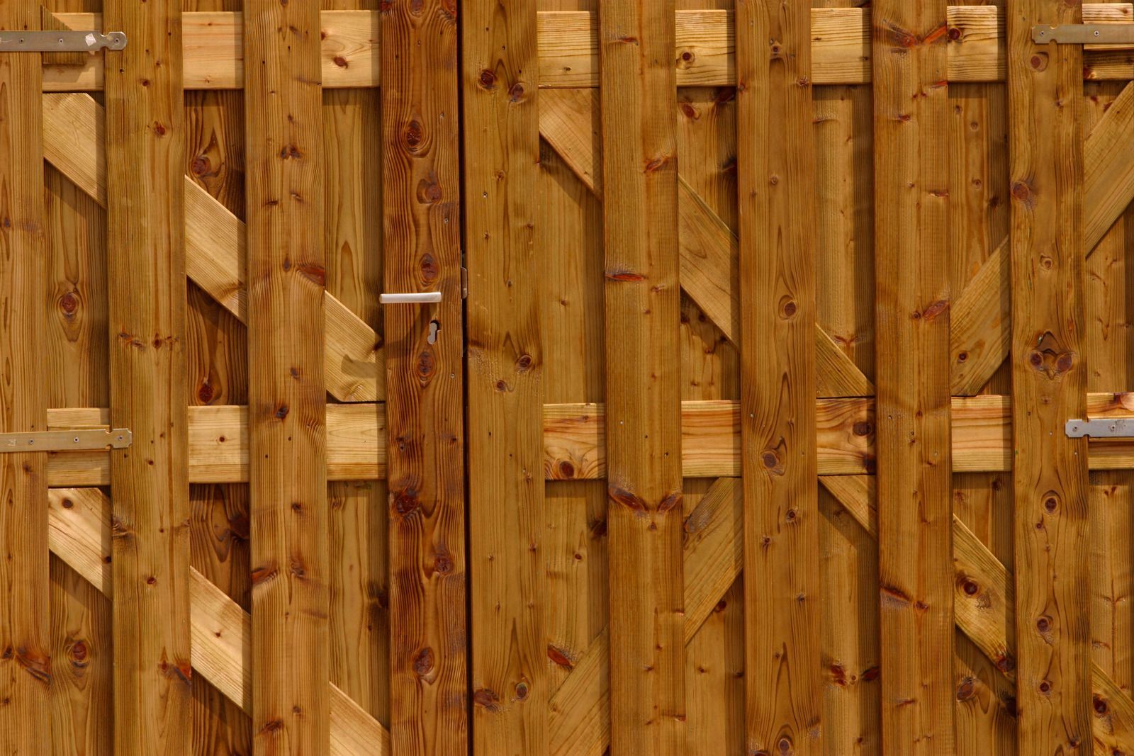 There is a fence in the backyard of a house.