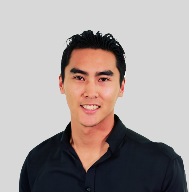 A man in a black shirt is smiling for the camera