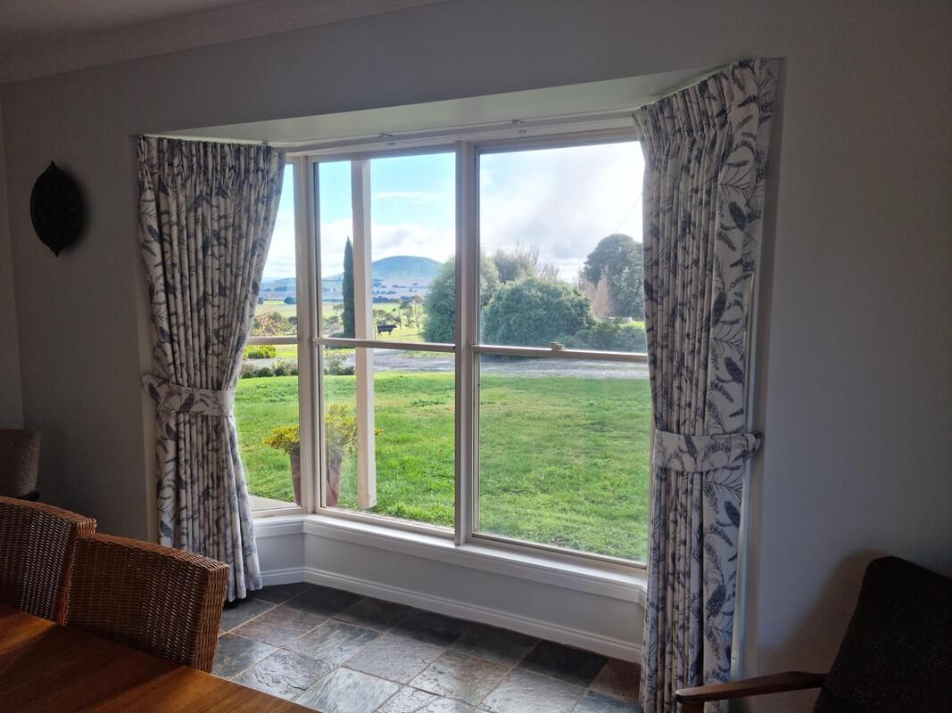 Draped Curtains Adorning Window - Luxaflex Curtains In Ballarat