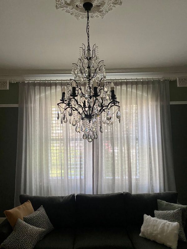 Graceful Chandelier Hanging Before Window - Luxaflex Window Furnishings In Ararat