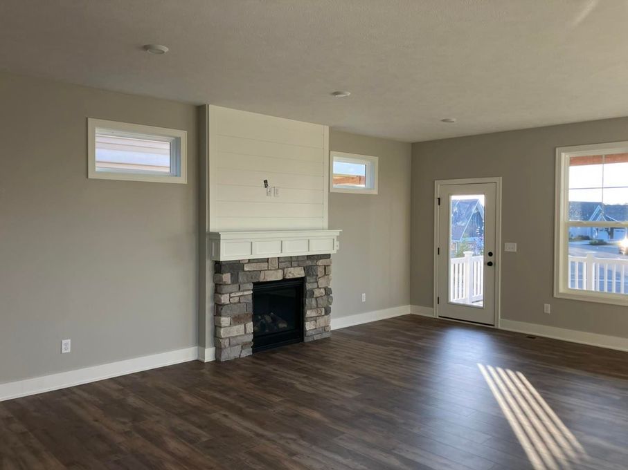 There is a fireplace in the middle of the living room.
