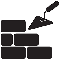 A trowel is being used to build a brick wall.