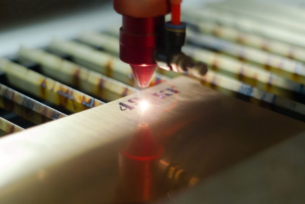 A Person is Cutting a Piece of Metal With a Laser — Total Engraving In Sandgate, NSW