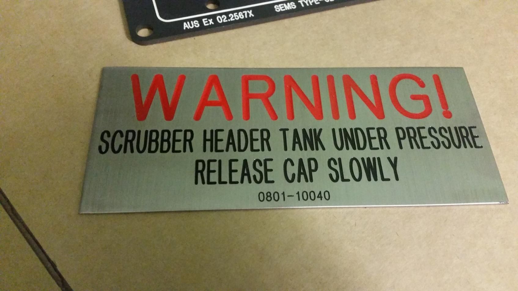 A Warning Sign That Says Scrubber Header Tank Under Pressure Release Cap Slowly — Total Engraving In Sandgate, NSW