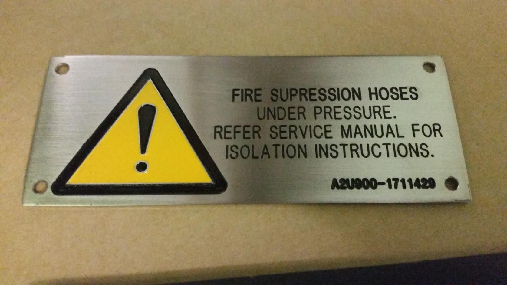 A Sign That Says Fire Suppression Hoses Under Pressure — Total Engraving In Sandgate, NSW