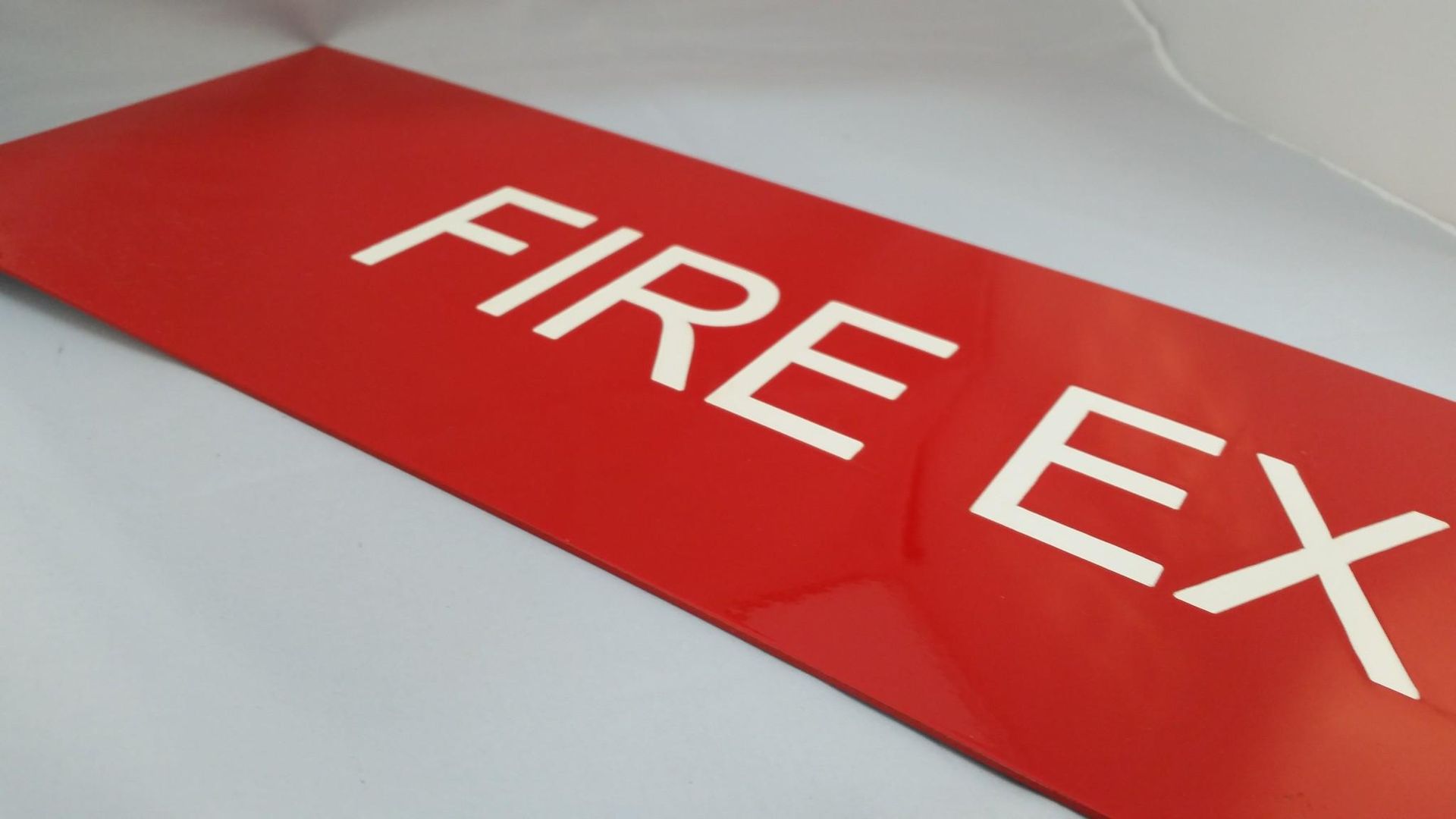 A Red Sign That Says Fire Ex on It — Total Engraving In Sandgate, NSW