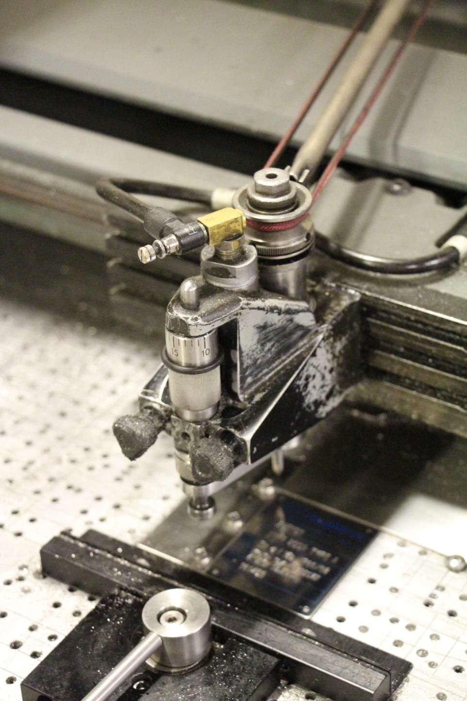 A Close Up of a Machine That is Cutting a Piece of Metal — Total Engraving In Sandgate, NSW