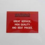 A Red Warning Sign That Says Great Service, High Quality and Best Prices — Total Engraving In Sandgate, NSW