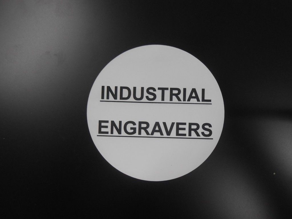 A White Circle With the Words Industrial Engravers on It — Total Engraving In Sandgate, NSW