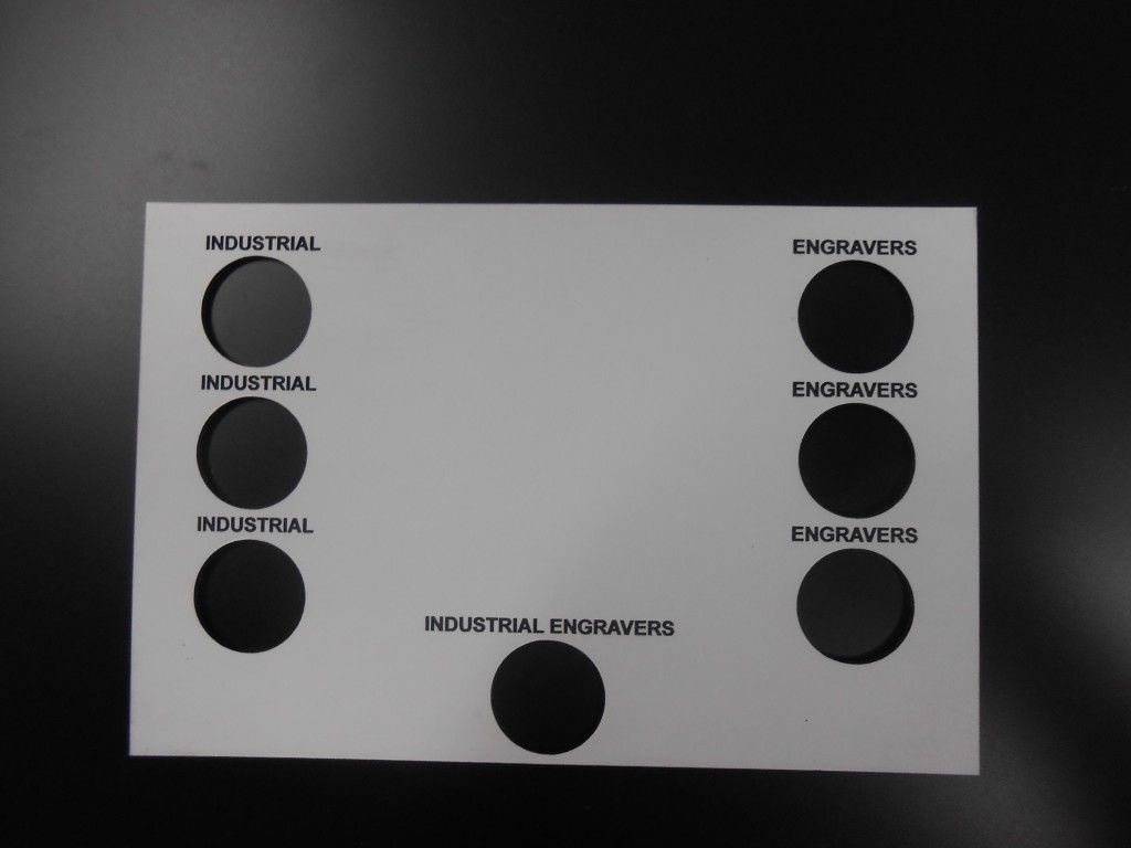 A White Piece of Paper With Black Circles and the Words Industrial on It — Total Engraving In Sandgate, NSW