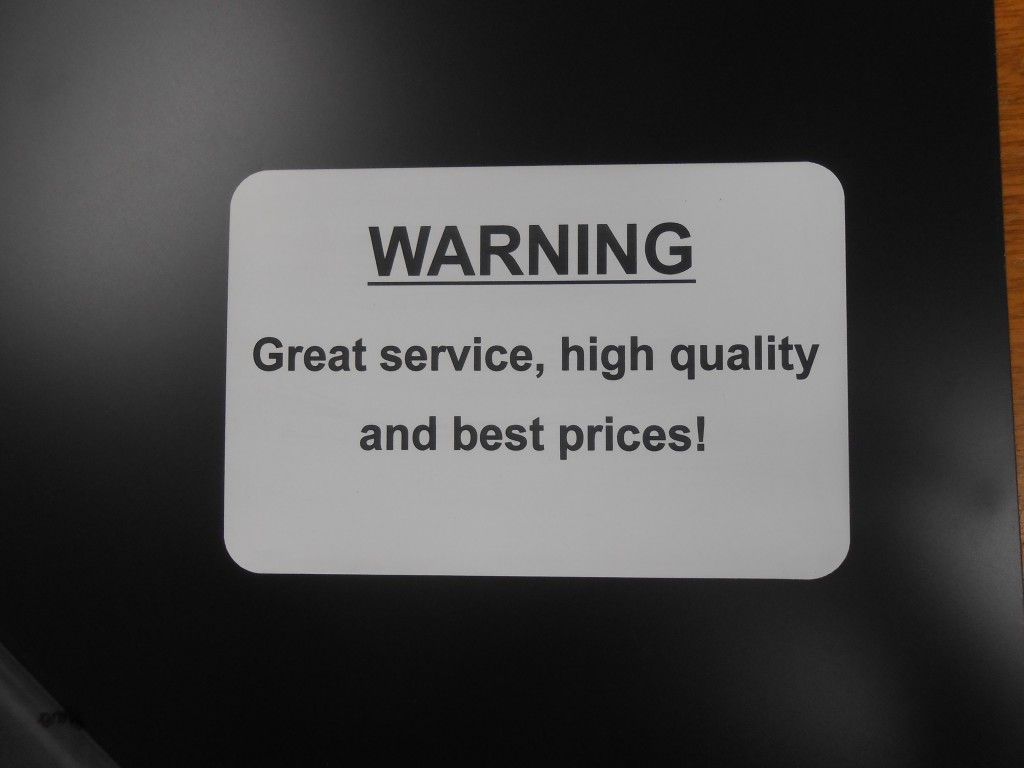 A sketch of a warning sign is on a black table before engraving process — Total Engraving In Sandgate, NSW