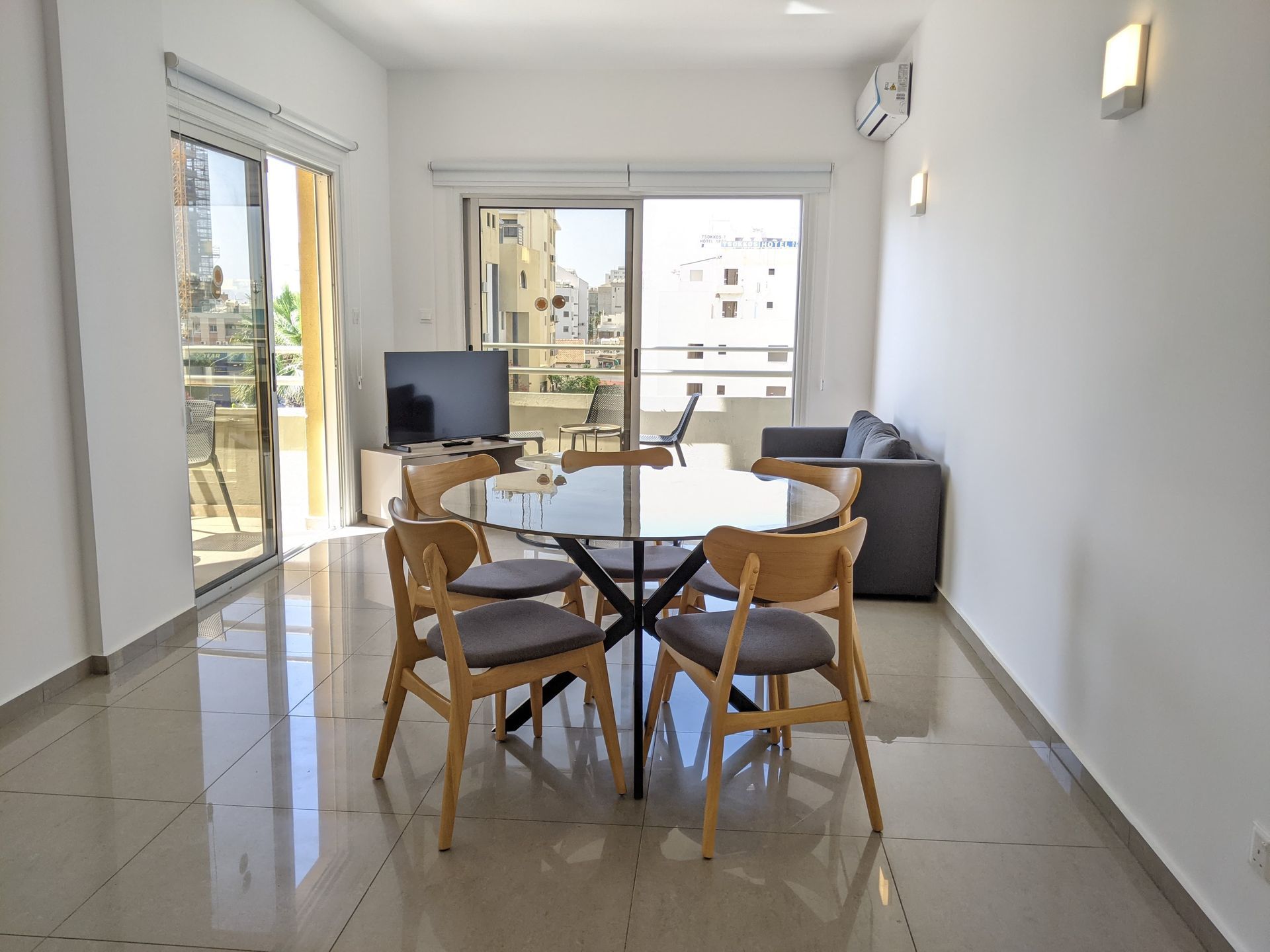 A living room with a table and chairs in it