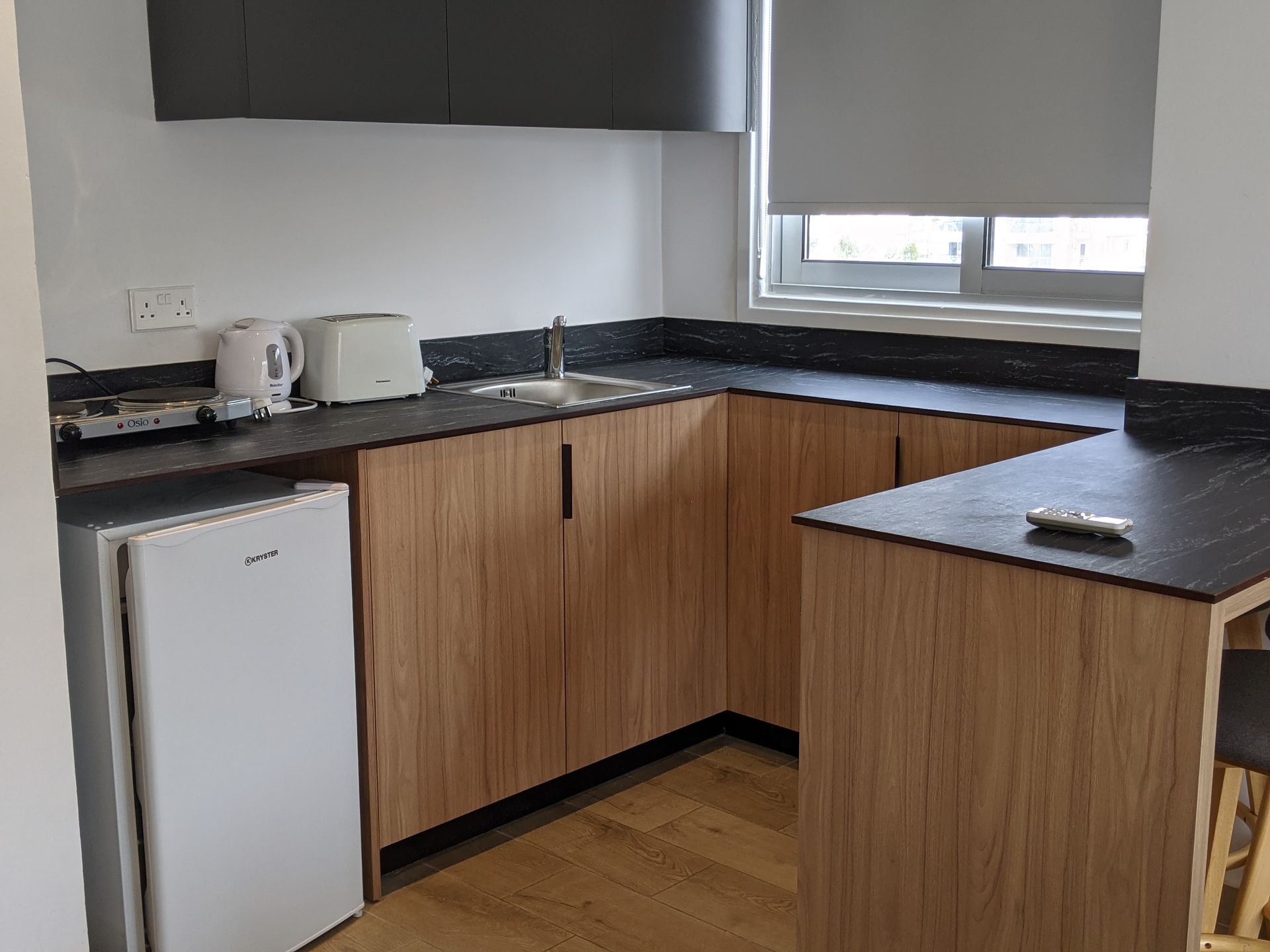 A kitchen with wooden cabinets and a white refrigerator.