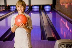 Boy Holding Bowling Ball — Bowling Center in Colorado Springs, CO