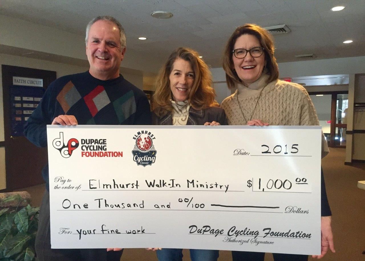 A man and two women holding a check for one thousand dollars