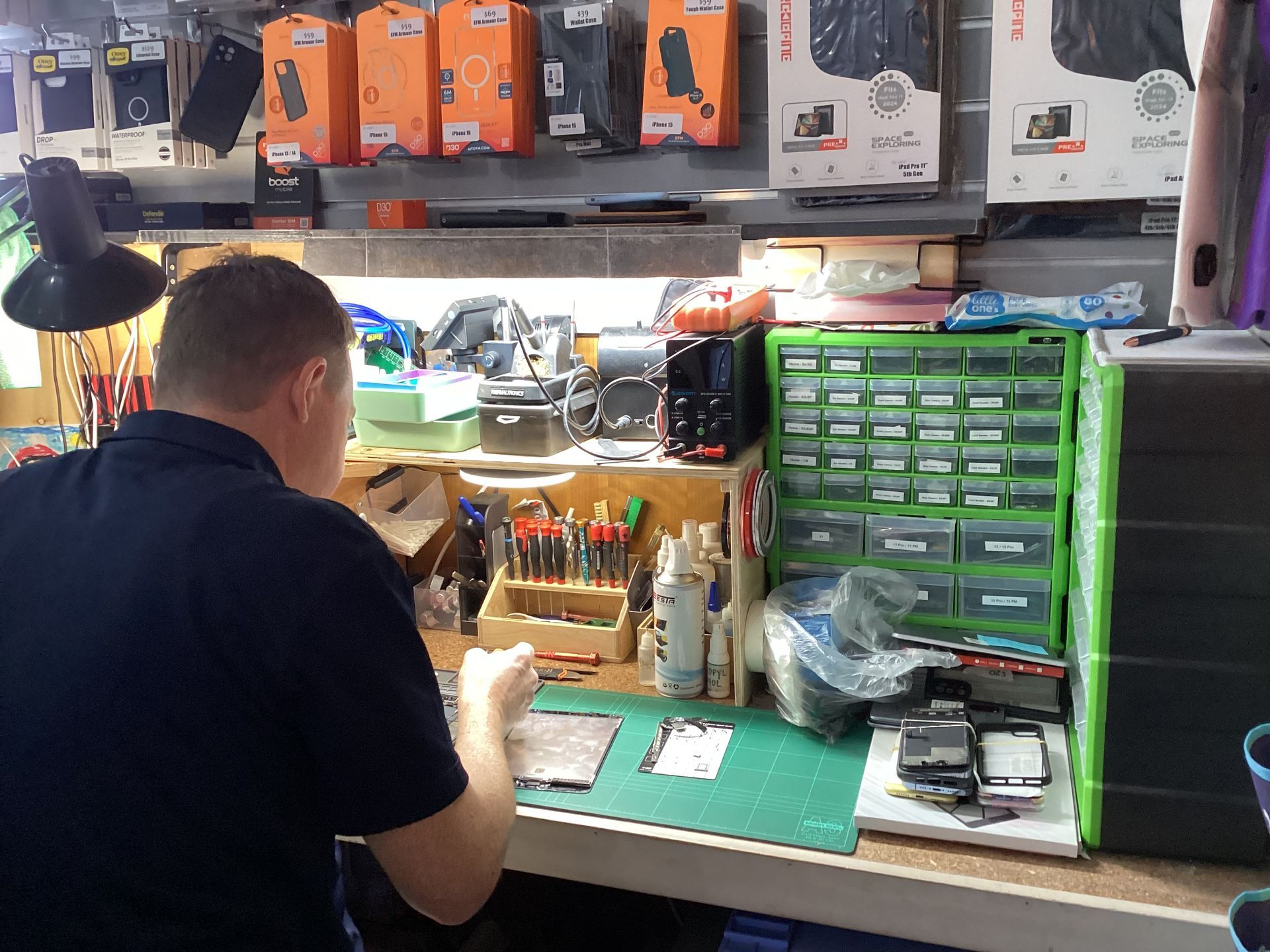 Man Standing in A Phone Repair Shop — DevicePro - Phone & Tablet Specialist In Cannonvale, QLD