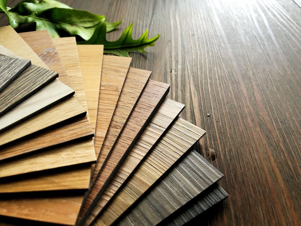 A fan of wooden samples on a wooden table.