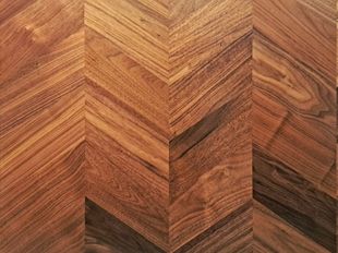 A close up of a wooden surface with a chevron pattern.