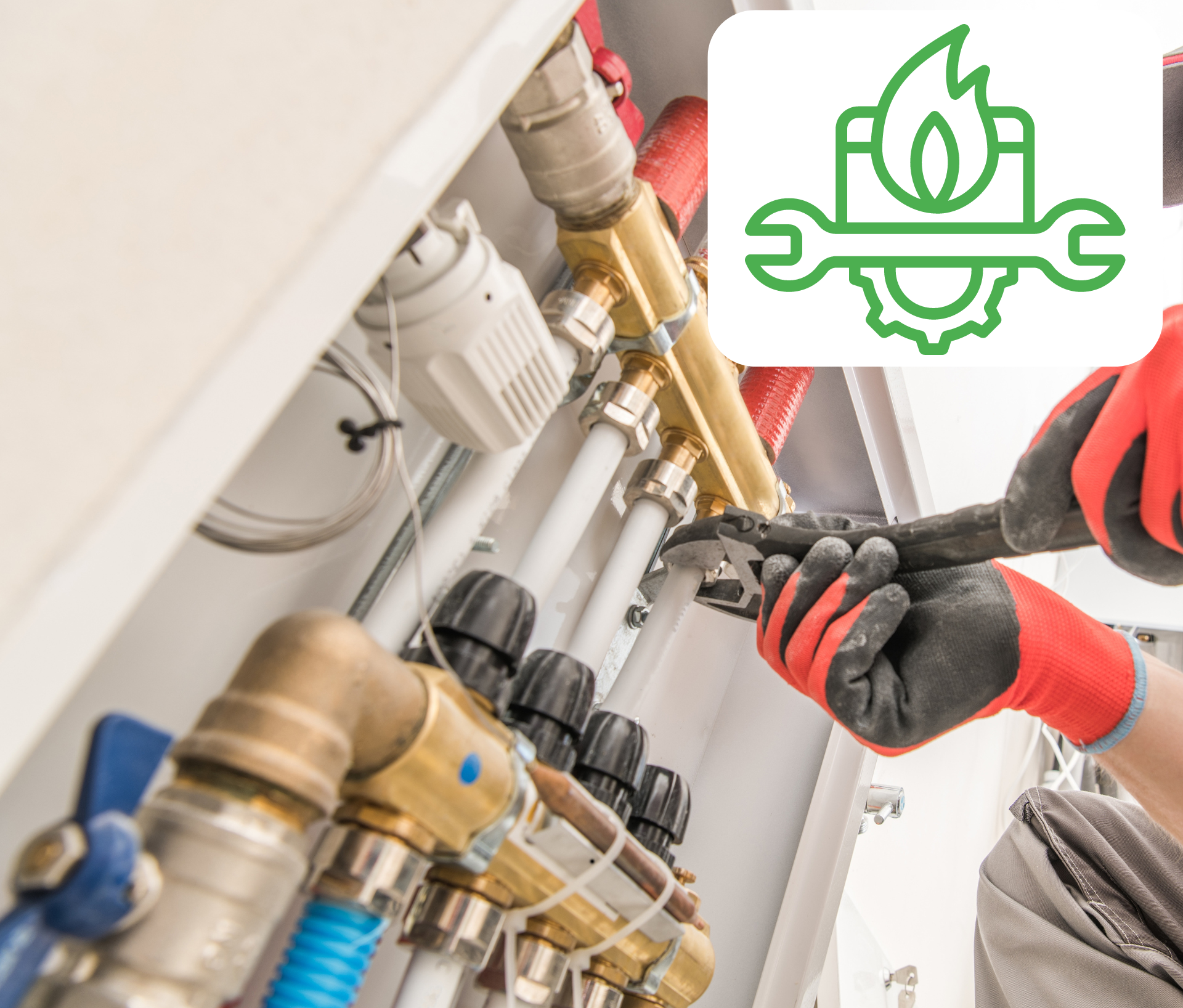 Un plombier travaille sur un tuyau avec une clé.