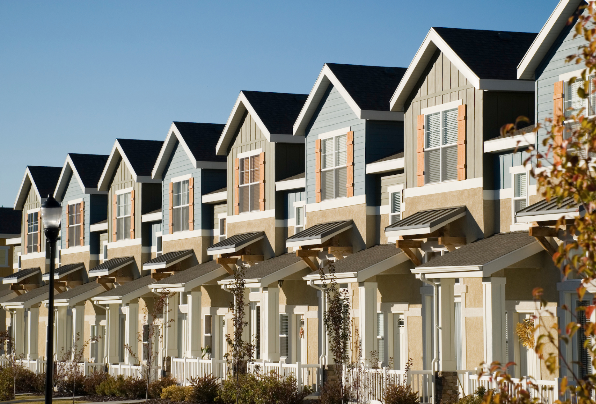 A man is giving a key to another man while sitting at a table.