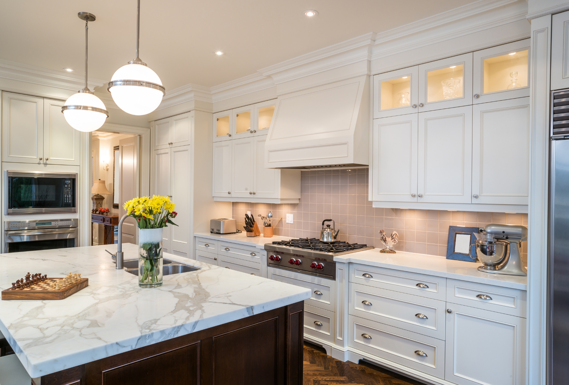 A person is typing on a laptop computer on a white table.