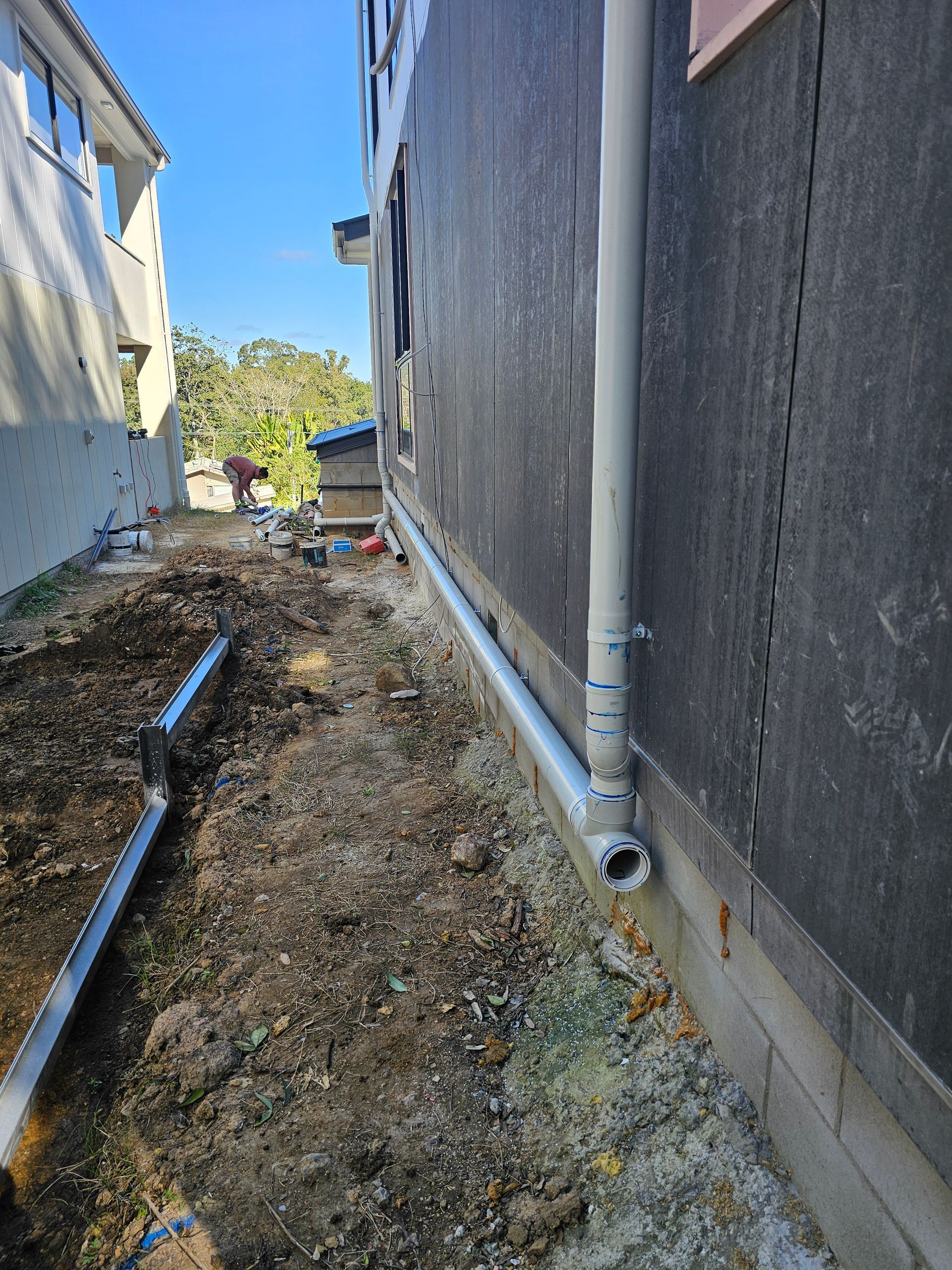 Plumbing Pipes Being Installed To Side Of House — Blueline Plumbing Services in Loganlea, QLD