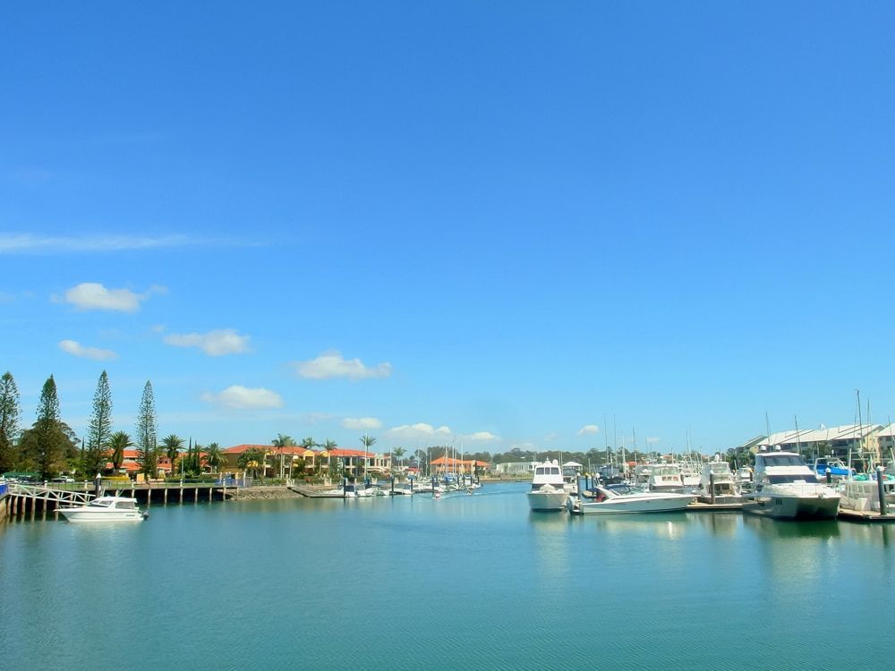 Boats Are Docked In A Harbor On A Sunny Day — Blueline Plumbing Services in Cleveland, QLD