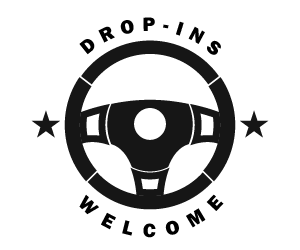 A black and white logo with a steering wheel and the words drop ins welcome