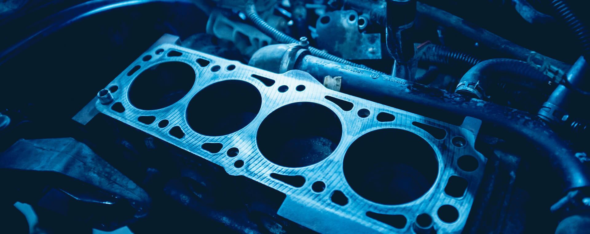 A close up of a cylinder head on a car engine.