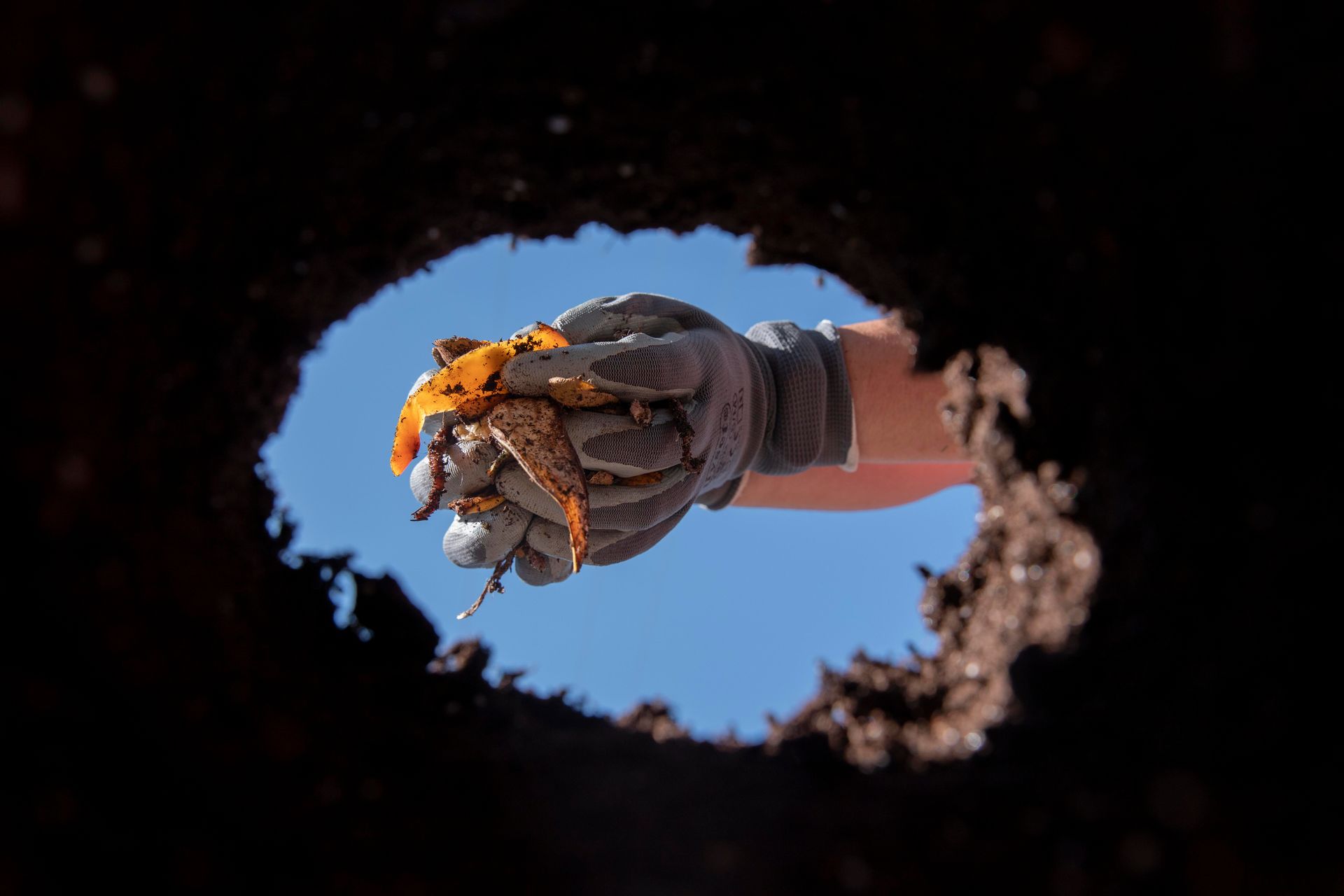 A person digging up a sinkhole.