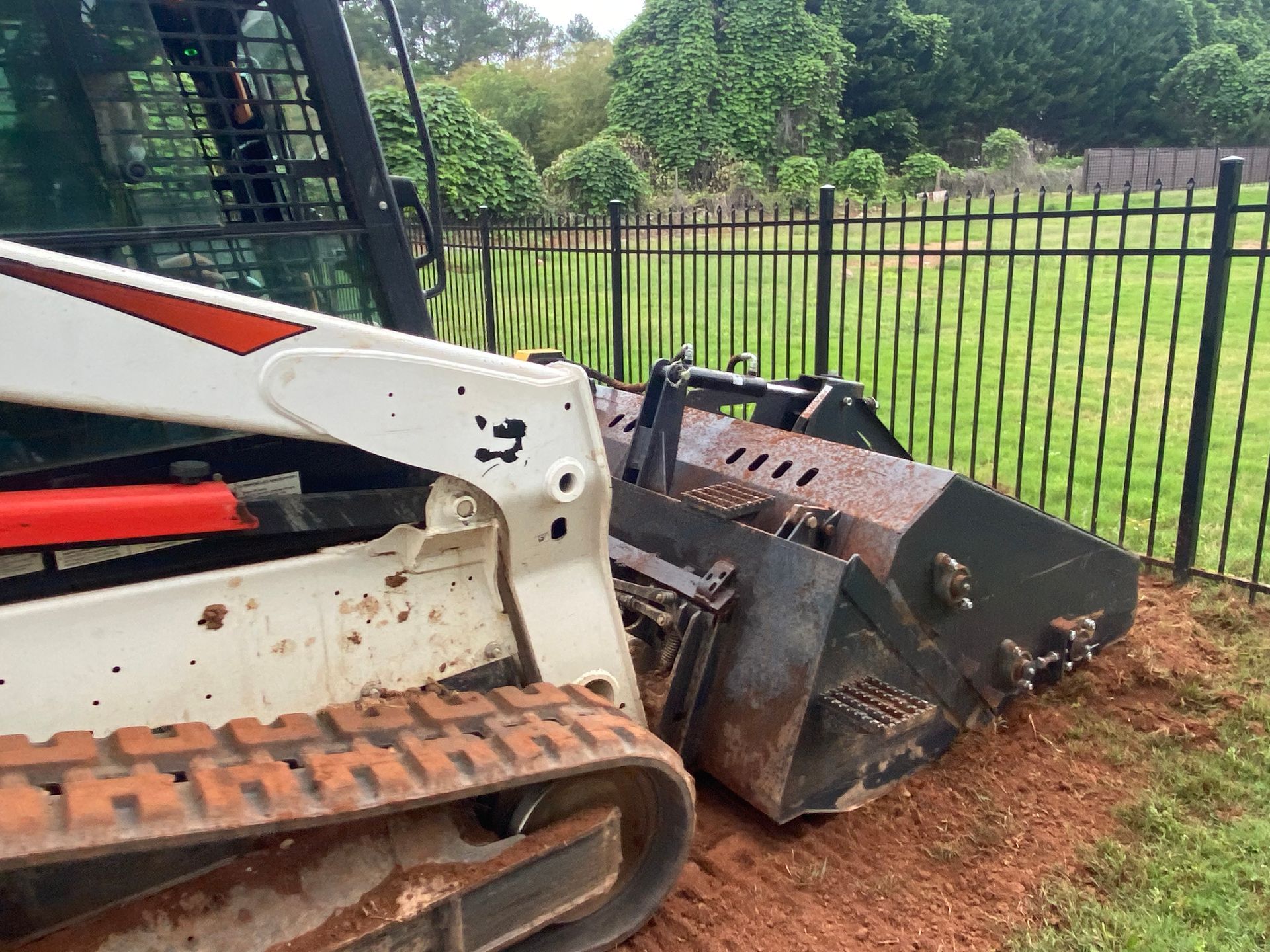 A yellow bulldozer is laying on its side in the dirt.